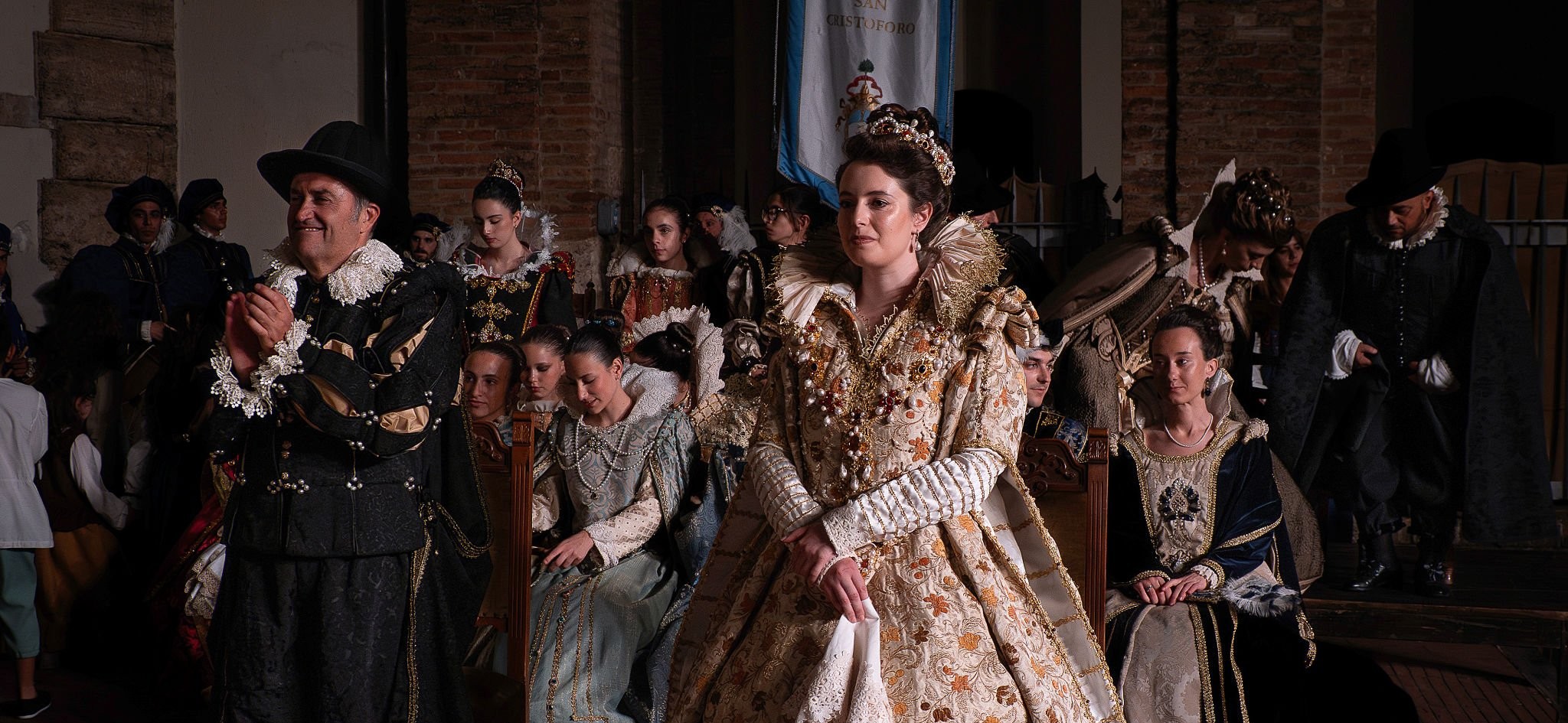 Renaissance dancers in a candlelit great hall